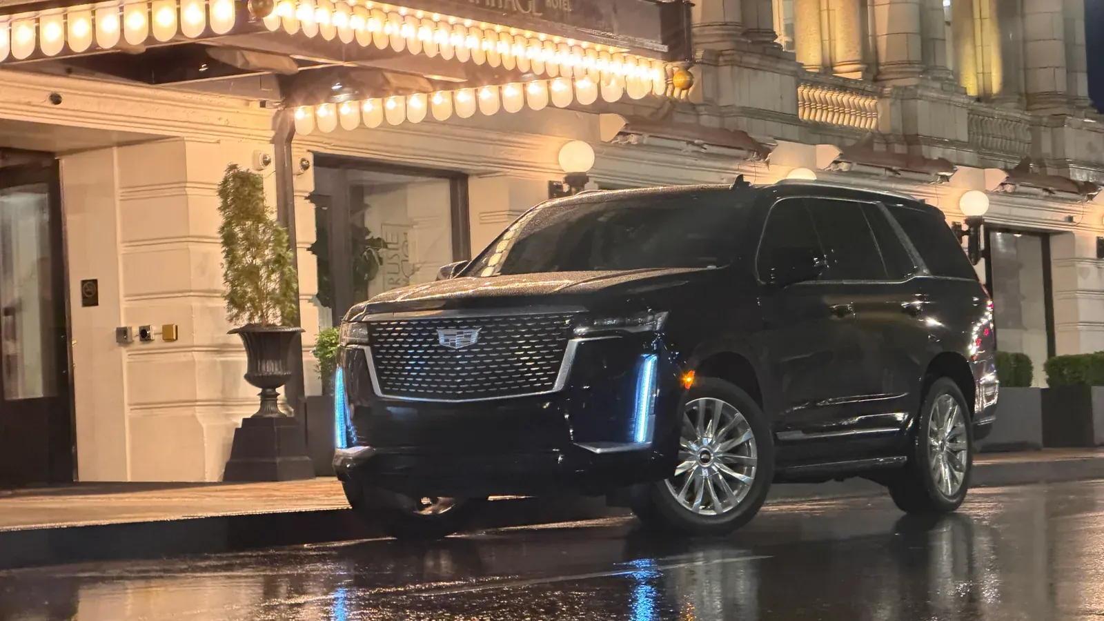 Black Cadillac Escalade arriving at a Nashville hotel entrance