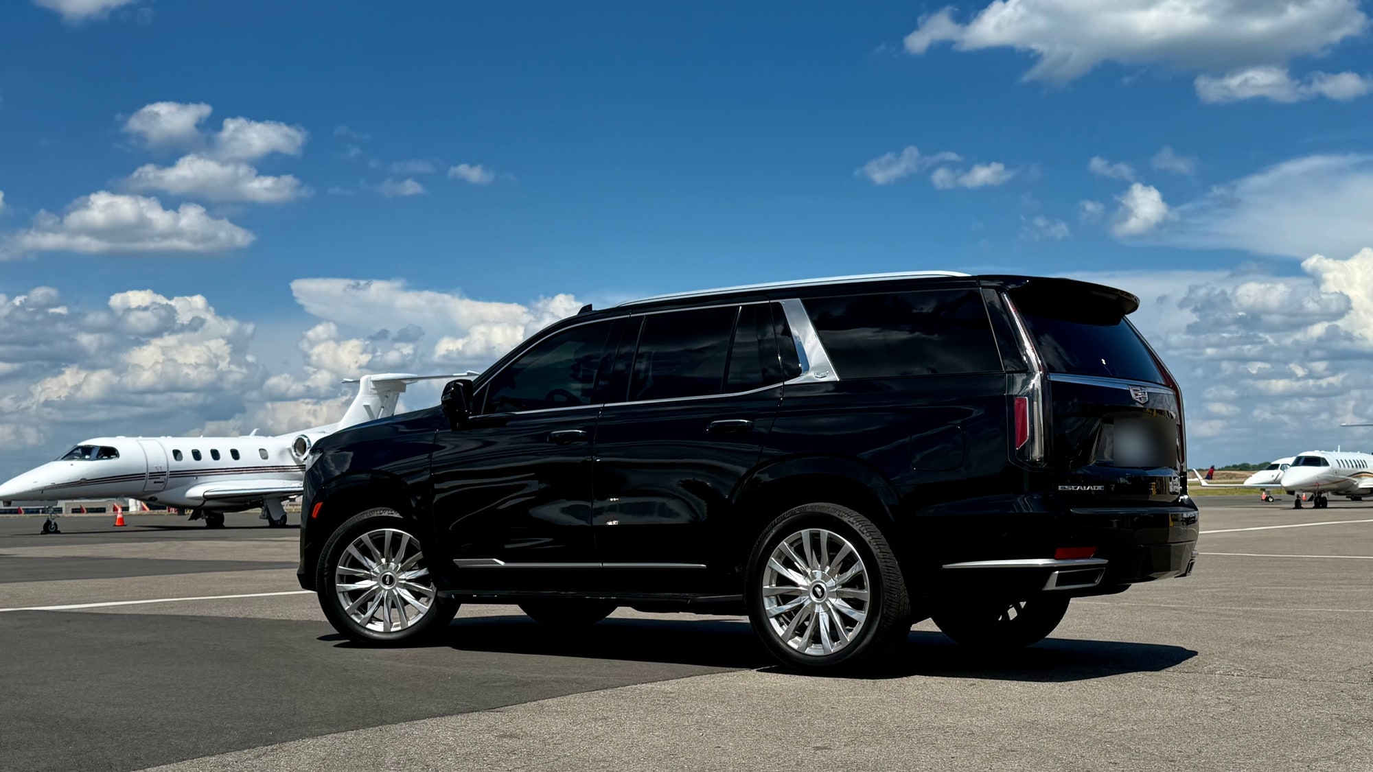 Cadillac Escalade beside private aircraft for FBO runway service in Nashville