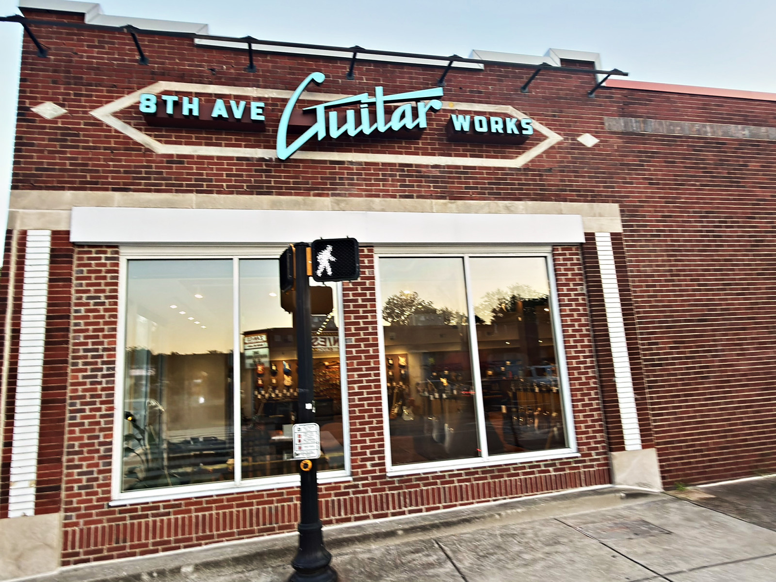 8th Ave Guitar Works storefront with its script sign above the window on 8th Avenue South in Nashville
