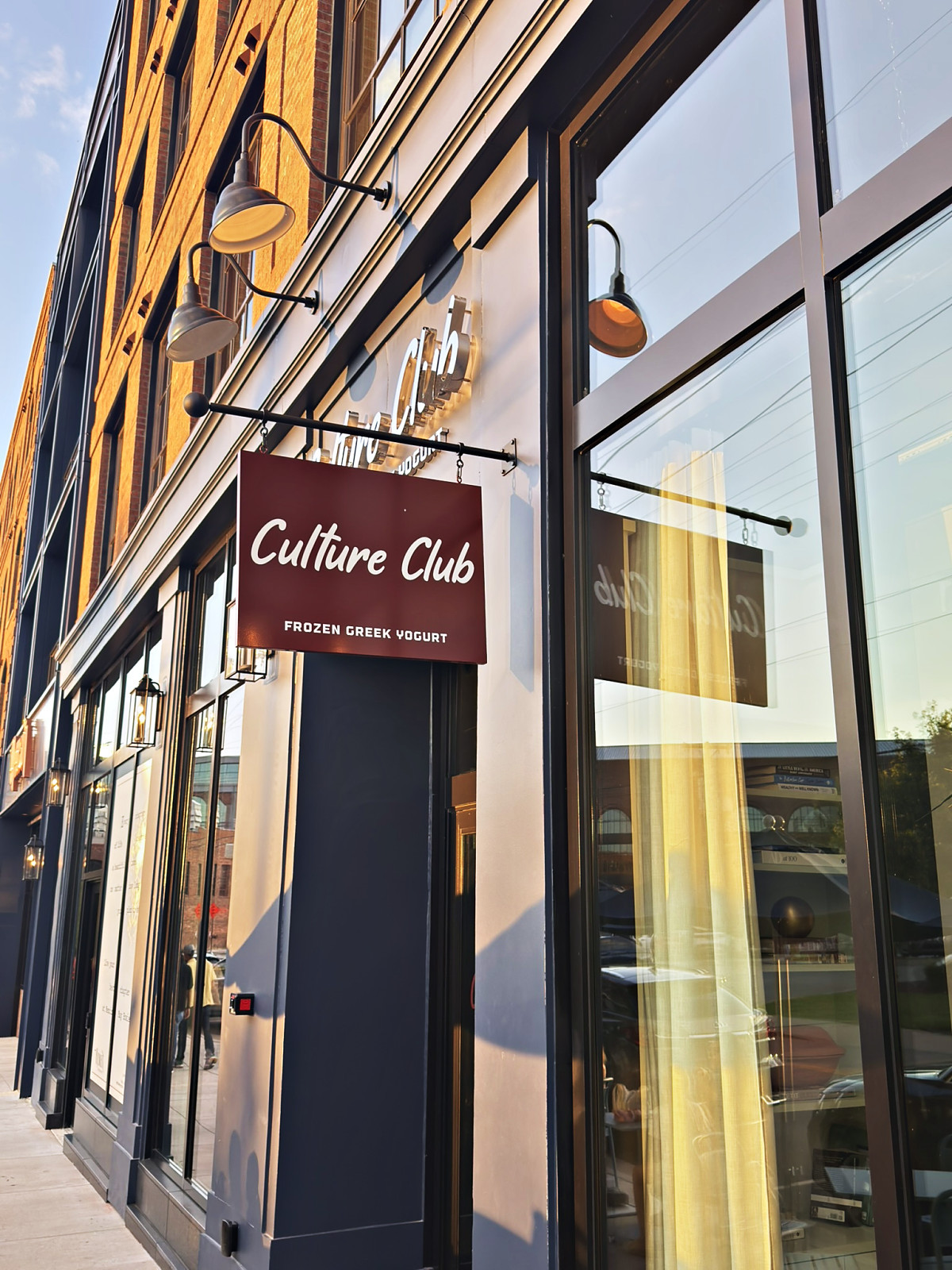 The Culture Club frozen Greek yogurt hanging sign outside its glass storefront in Wedgewood-Houston, Nashville