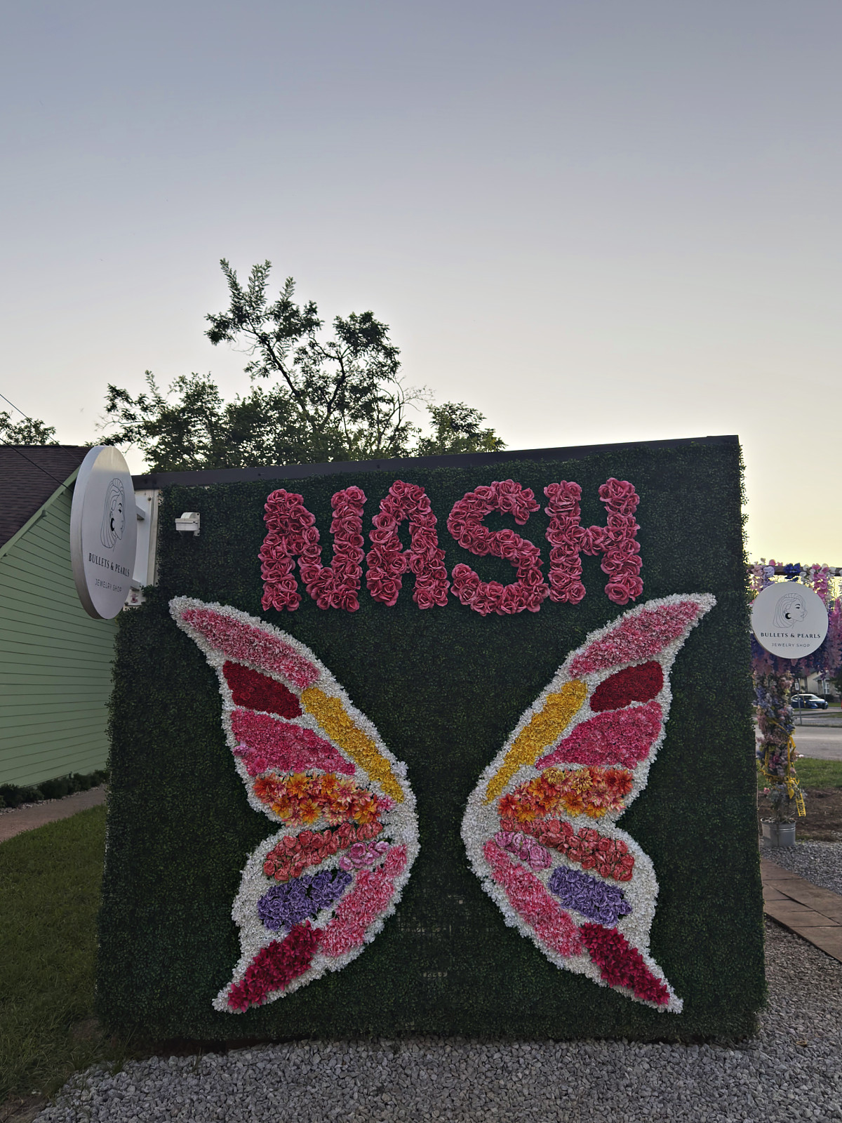 The NASH butterfly wings mural on a green hedge wall in Nashville's 12 South neighborhood