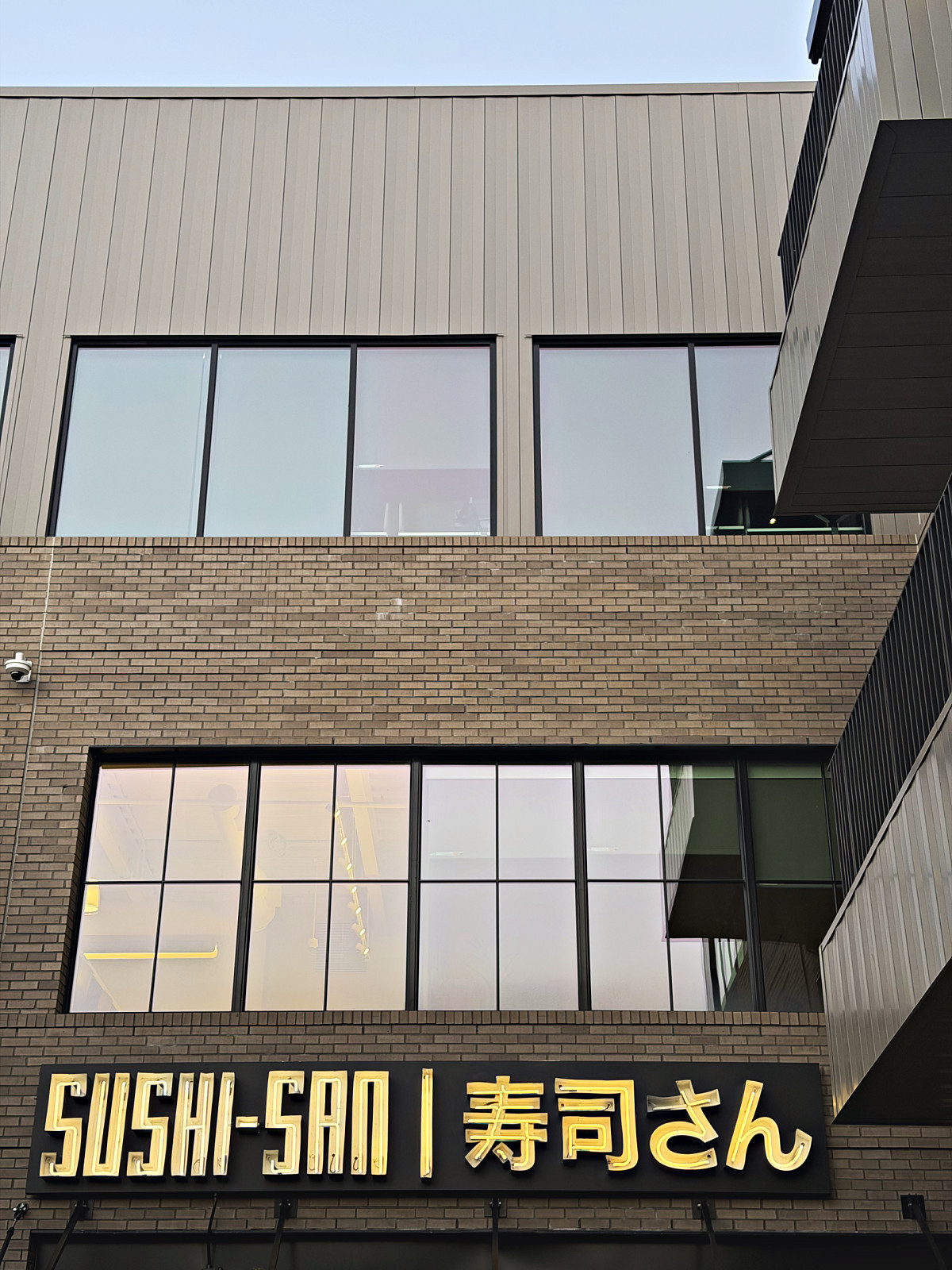 Sushi-San restaurant sign in English and Japanese lettering on 12th Avenue South in Nashville
