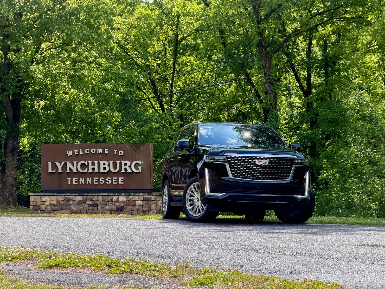 Cadillac Escalade beside the Welcome to Lynchburg, Tennessee sign