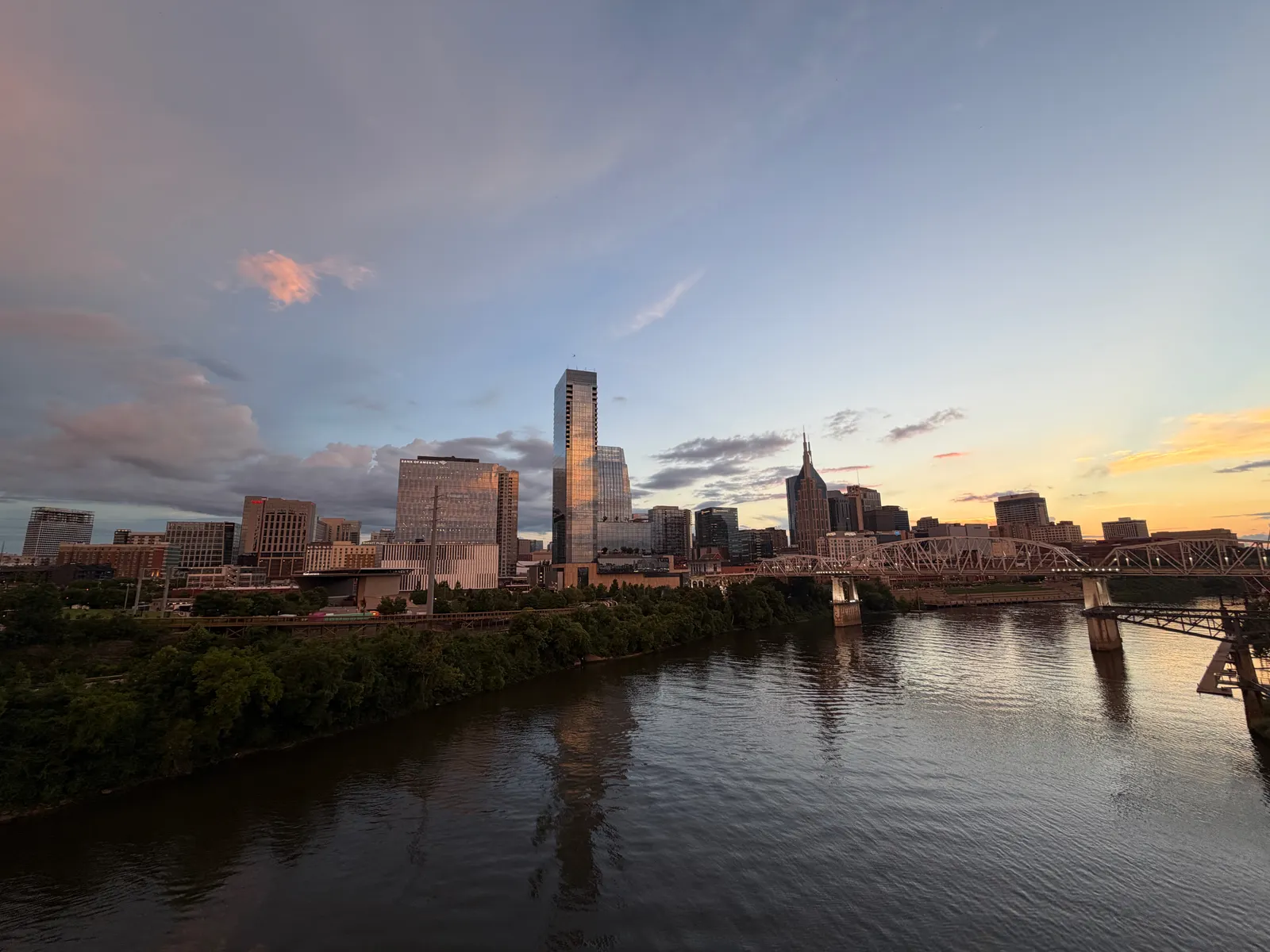 Nashville skyline and river beneath a colorful sunset