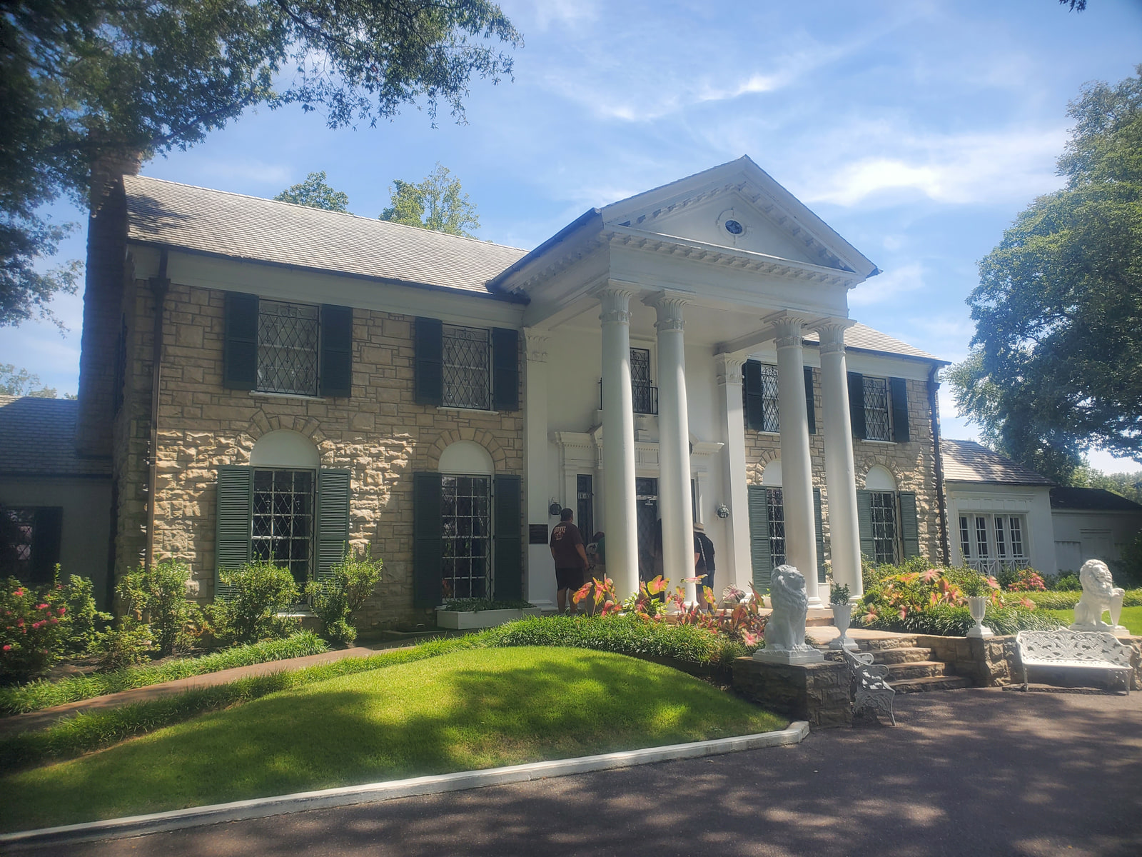 Graceland mansion with white columns, stone exterior, and landscaped grounds in Memphis
